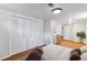 Well-lit bedroom featuring closet and dresser and light carpet at 6769 S Foresthill St, Littleton, CO 80120