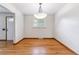 Bright dining room with hardwood floors and a decorative light fixture at 6769 S Foresthill St, Littleton, CO 80120