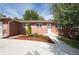 Charming brick home with a well-manicured front yard and a concrete driveway under a sunny sky at 6769 S Foresthill St, Littleton, CO 80120