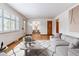 Open-concept living room with wood floors, neutral décor, and an adjoining dining area at 6769 S Foresthill St, Littleton, CO 80120