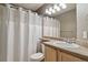 This bathroom has a large mirror and a white shower curtain and a single sink vanity at 1484 Nemrick Pl, Castle Rock, CO 80109