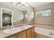 The bathroom features a double sink vanity, large mirror, and tiled walls and backsplash at 1484 Nemrick Pl, Castle Rock, CO 80109