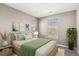 This bedroom has two windows and is decorated with botanical wall art and a green throw blanket at 1484 Nemrick Pl, Castle Rock, CO 80109