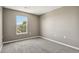 This bedroom features neutral walls and carpeting and a large window for natural light at 1484 Nemrick Pl, Castle Rock, CO 80109