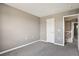 Neutral walls and carpeting feature in this bedroom, along with a doorway looking out to the landing at 1484 Nemrick Pl, Castle Rock, CO 80109