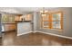 Dining room with wood floors, windows, and light wood cabinets at 1484 Nemrick Pl, Castle Rock, CO 80109