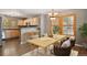 Dining area with a wooden table, modern chairs, and light wood cabinets at 1484 Nemrick Pl, Castle Rock, CO 80109
