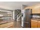 Updated kitchen with stainless steel refrigerator and easy access to the living area at 1484 Nemrick Pl, Castle Rock, CO 80109