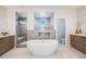 Elegant bathroom with a soaking tub, glass shower, and and vanities at 11303 Tango Ln, Parker, CO 80134