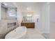 A luxurious bathroom with a soaking tub, a vanity with dual sinks, and a modern shower at 11303 Tango Ln, Parker, CO 80134