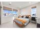 Bright bedroom featuring three windows, a queen bed, and a dedicated workspace at 11303 Tango Ln, Parker, CO 80134