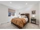 This bedroom features a large bed, neutral colors, and a window for ample natural light at 11303 Tango Ln, Parker, CO 80134