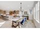 Dining area with a wooden table, blue upholstered chairs, and an open view into the kitchen at 11303 Tango Ln, Parker, CO 80134