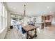 Dining area with stylish light fixture and seating adjacent to a modern open-plan kitchen at 11303 Tango Ln, Parker, CO 80134