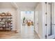 Bright entryway leads to a living room with large windows and wood-style flooring at 11303 Tango Ln, Parker, CO 80134