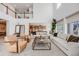 Bright living room showcases vaulted ceilings, stylish furniture, and seamless flow to the kitchen at 11303 Tango Ln, Parker, CO 80134