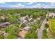 Aerial view showing tree lined neighborhood with the city skyline in the background at 1457 S Franklin St, Denver, CO 80210