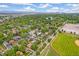 Aerial view of neighborhood near downtown with tree coverage, a pond, baseball field, and mountain views at 1457 S Franklin St, Denver, CO 80210