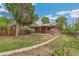 A spacious backyard with a covered patio and mature trees, perfect for outdoor entertaining at 1457 S Franklin St, Denver, CO 80210
