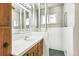This bathroom features a vanity, sink, mirror, and green tiling at 1457 S Franklin St, Denver, CO 80210
