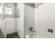 A fully tiled bath and shower combination with shower head and faucet fixtures at 1457 S Franklin St, Denver, CO 80210