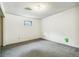 This room features neutral walls, carpet, and a small window for natural light at 1457 S Franklin St, Denver, CO 80210