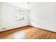 Bedroom featuring hardwood floors and a window with blinds at 1457 S Franklin St, Denver, CO 80210