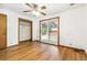 Bright bedroom with hardwood floors, sliding glass door, ceiling fan and open closet at 1457 S Franklin St, Denver, CO 80210