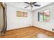 Bedroom featuring hardwood floors, ceiling fan, and windows with wooden shutters at 1457 S Franklin St, Denver, CO 80210