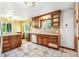 Charming kitchen boasts wooden cabinets and tile countertops with a stainless-steel dishwasher at 1457 S Franklin St, Denver, CO 80210