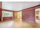 Bright living room featuring hardwood floors that flow seamlessly into the adjacent entryway and kitchen at 1457 S Franklin St, Denver, CO 80210