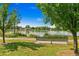 Scenic park view with a peaceful lake, walking path, and a comfortable bench for enjoying nature's beauty at 1457 S Franklin St, Denver, CO 80210