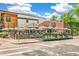Street view with outdoor patio seating, umbrellas, and a mix of modern and brick building facades at 1457 S Franklin St, Denver, CO 80210