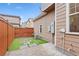 Cozy backyard with artificial turf, stepping stones, and a paved patio area at 7602 S Yakima Ct, Aurora, CO 80016