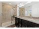 Bathroom with double sinks, granite countertop, and a walk-in shower at 7602 S Yakima Ct, Aurora, CO 80016