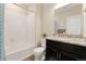 Clean bathroom with a tub-shower combo, granite countertop vanity, and modern fixtures at 7602 S Yakima Ct, Aurora, CO 80016