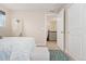 Neutral bedroom with a view of the stairs and featuring a full-length mirror at 7602 S Yakima Ct, Aurora, CO 80016