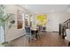 Bright dining room features wood floors, large windows, and stylish decor at 7602 S Yakima Ct, Aurora, CO 80016