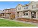 Attractive two-story home with stone accents, covered porch, and manicured front yard at 7602 S Yakima Ct, Aurora, CO 80016