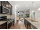 Modern kitchen with stainless steel appliances, granite countertops, and dark cabinetry at 7602 S Yakima Ct, Aurora, CO 80016