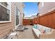 Private outdoor patio featuring a comfortable wicker couch and a fenced-in backyard at 7602 S Yakima Ct, Aurora, CO 80016