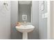 Charming powder room with pedestal sink and neutral paint at 7602 S Yakima Ct, Aurora, CO 80016