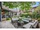 Inviting backyard featuring patio seating, lush greenery, and charming outdoor space perfect for entertaining at 4570 Irving St, Denver, CO 80211