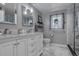 Bathroom vanity with dual sinks, a large mirror, pendant lights, and modern fixtures at 4570 Irving St, Denver, CO 80211