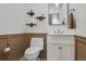 Stylish powder room with modern fixtures, decorative tile flooring, and elegant wainscoting at 4570 Irving St, Denver, CO 80211