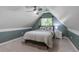 Charming bedroom with a slanted ceiling, soft carpeting, and a serene atmosphere at 4570 Irving St, Denver, CO 80211