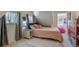 Cozy bedroom with sloped ceilings, plush carpet, a neutral color scheme, and soft natural light at 4570 Irving St, Denver, CO 80211