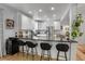 Bright kitchen features white cabinets, stainless steel appliances and black countertop bar with seating at 4570 Irving St, Denver, CO 80211