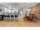 Open-concept kitchen with sleek countertops and dining area with brick wall and stylish lighting at 4570 Irving St, Denver, CO 80211