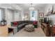 Bright living room featuring a plush gray sectional sofa, stylish ottoman, and decorative accents at 4570 Irving St, Denver, CO 80211